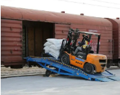 Electric handling vehicles for cargo loading, unloading, and transportation in railway freight yards